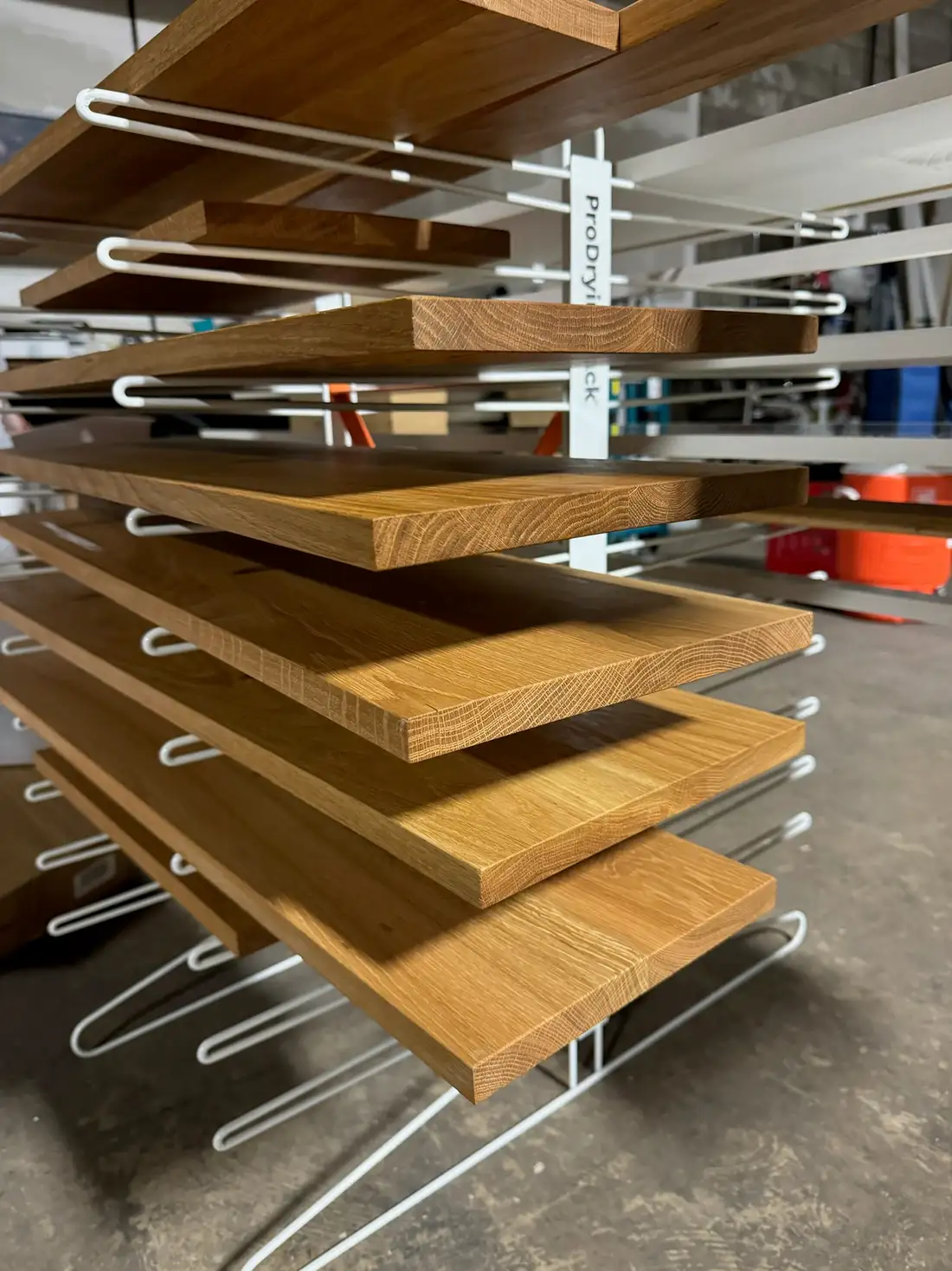 Oak panels stacked on the drying rack in the Somersworth shop